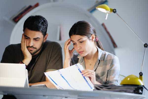 a couple looking at financial documents